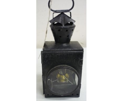 Early black Japanned metal railway lamp, with clear lenses and internal burner, the case painted W Wainwright (height 26cm) 