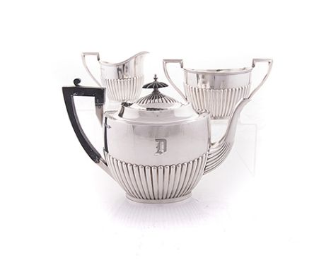 AN ASSEMBLED THREE-PIECE SILVER TEA SET, WALKER & HALL, SHEFFIELD, 1911 & 1918 comprising: a teapot, milk jug and a two-handl