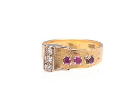 A RUBY AND DIAMOND RING designed as a buckle and strap, set to the side with three round brilliant-cut diamonds weighing appr
