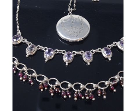A Scandinavian silver and graduated amethyst stylised necklace, a sterling and garnet bracelet, and a silver locket pendant n