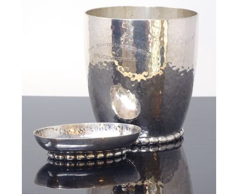 EVALD NIELSEN - an early 20th century Danish silver stylised matching beaker and pin tray, planished decoration with beaded f