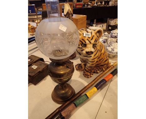 Mixed lot including a bed pan two walking sticks ornamental tiger and an oil lamp 