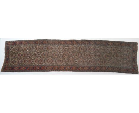 Bidjar woollen runner, circa 1900, fawn field with a herati of flowerheads and crescent form foliage in reds, greens and blue