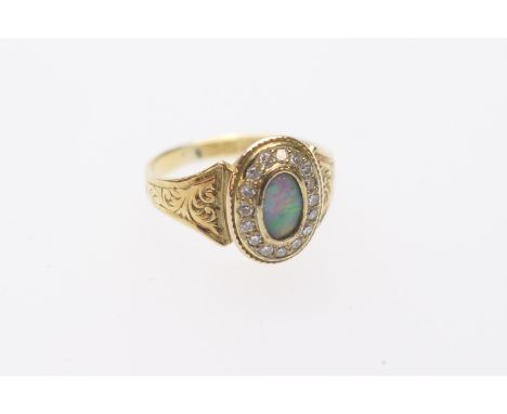 Edwardian opal and diamond memorial cluster ring in 15ct gold, the opal approx. 7mm x 4mm, bordered with small round cut diam