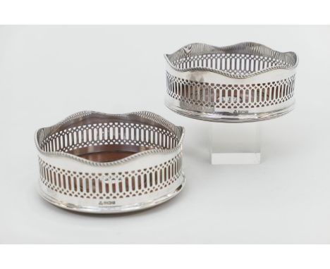 Pair of Elizabeth II silver wine coasters, Sheffield 1991, each with turned wooden bases centred with a silver button, 14cm d