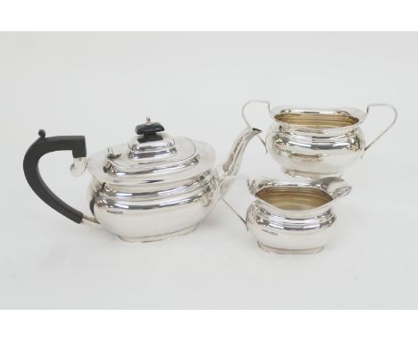 George VI silver three piece tea service, maker HF&amp;Co., Sheffield 1940, comprising a bombe form teapot with ebony and han