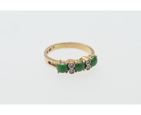 Cabochon jade and diamond ring, in 14ct yellow gold, three cabochon jades dispersed with four tiny illusion set diamonds, the