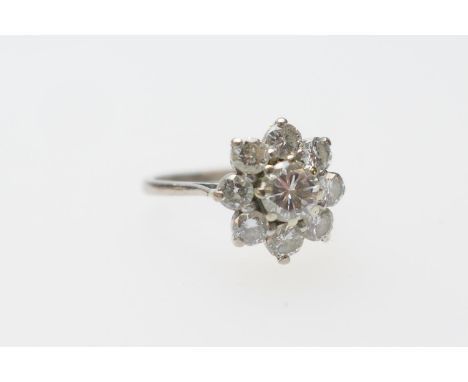 Diamond cluster ring, the central round cut diamond of approx. 0.95ct, estimated as K/L in colour and clarity as SI, bordered