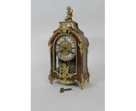 French boulle mantel clock, circa 1880, the case surmounted with a cherub and gilt ormolu embellishments throughout, enclosin