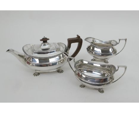 George VI silver three piece tea service, maker GH, Sheffield 1937, comprising teapot of bombe form detailed with horizontal 