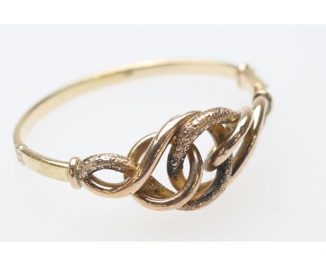 9ct gold hinged bangle, formed as an openwork knot, with a textured finish, cuff size 57mm, weight approx. 19.5g (Please note