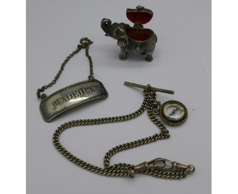 An elephant shaped pill box, an Albert chain with compass fob and a wine label