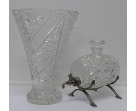 A large lead crystal glass vase and a crystal glass barrel shaped decanter on a plated stand, height of vase 31.5cm