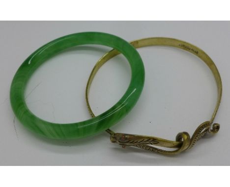 A jade bangle and snake arm bangle
