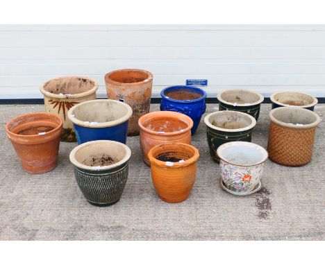 A group of 13 x ceramic and clay plant pots. Some patterns on pots include, flowers, cat, and similar. Largest is 38 cm in he