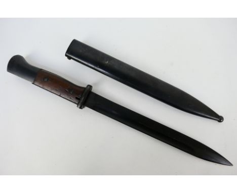 A German K98 bayonet, 25 cm single edged blade, with steel scabbard marked Gebr Heller 1939, Waffenampt stamps to the pommel.