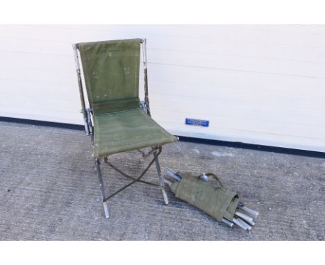 A pair of British army canvas and metal folding chairs, stamped with broad arrow and dated 1952. [2]. [SW].