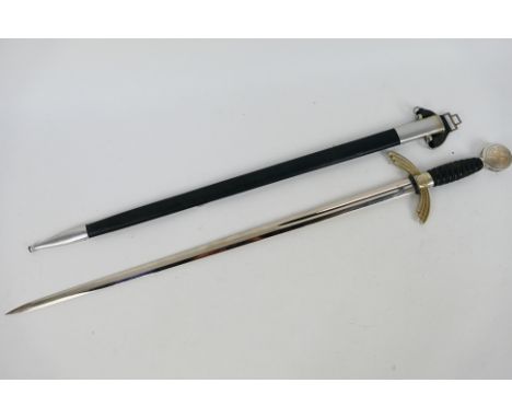 A post war example of a Luftwaffe officer's dress sword with scabbard, 67 cm (l) blade.Note: This lot is not for sale to peop