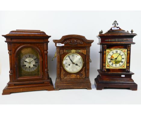 A good lot to include three mantel/ table clocks, the first an unusual oak cased example by Badische Uhrenfabrik, art nouveau