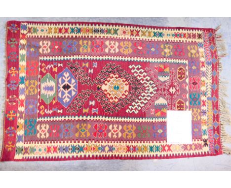 A Turkish wool rug, approximately 180 cm x 110 cm. [W]Condition Report: Appears in good condition overall, no significant dam