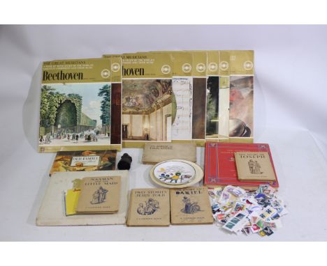A mixed lot to include foreign stamps, 'An Album of Film Stars' cigarette cards, 2 x ceramic plates, 9 x 'The Greatest Musici
