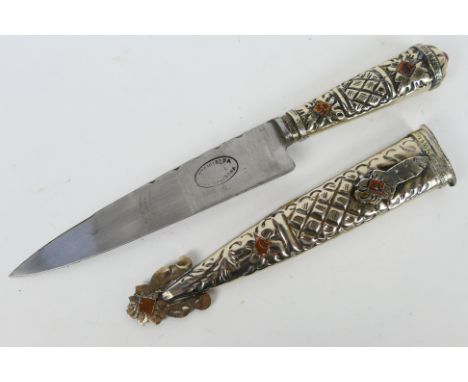 An Argentinian white and gilt metal Gaucho knife.Note: This lot is not for sale to people under the age of 18. By bidding on 
