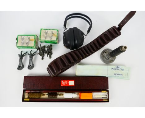Lot to include a shotgun ammunition belt, target launcher, cleaning kit, ear defenders and other.