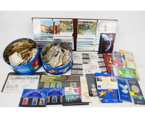 Philately - Two tins of loose stamps, uncirculated coins, binder of postcards and other. [SW]