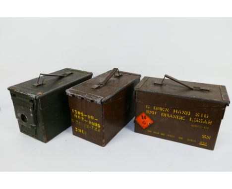 Three metal, military ammunition boxes.