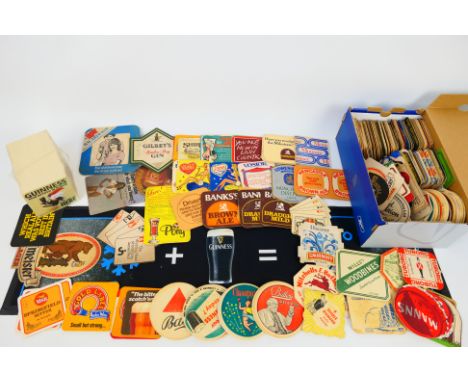 A collection of vintage beer mats including a full pack of Guinness examples and a Guinness bar mat.