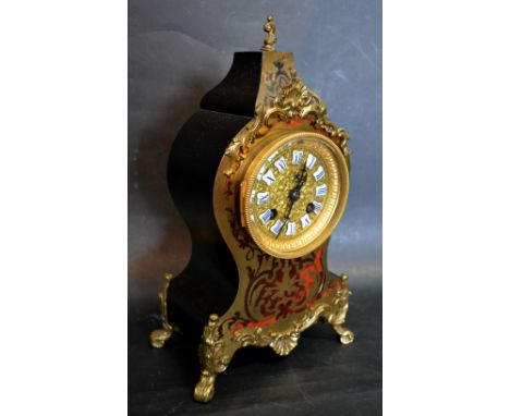 A 19th Century French Boulle Mantle Clock, the gilt metal dial with enamel tablet Roman numerals, the shaped case with gilt m
