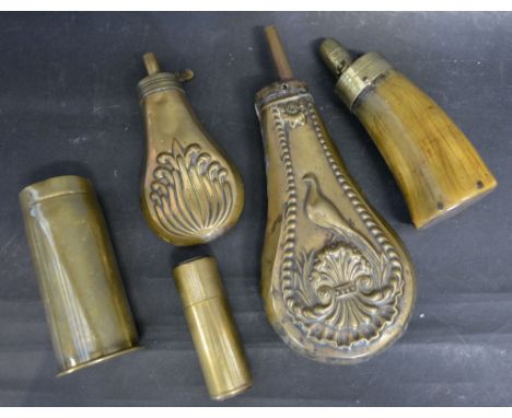 A 19th Century Embossed Brass Powder Flask together with another similar smaller, a horn powder flask and two shell cases