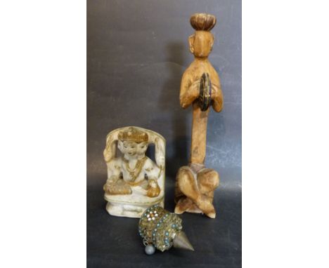 An Asian Alabaster Model in the form of a Goddess together with a carved wooden figure and a metal turquoise mounted prayer w