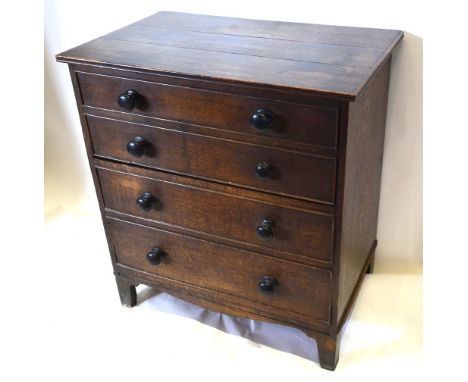 A George III Oak Commode Chest with knob handles raised upon bracket feet