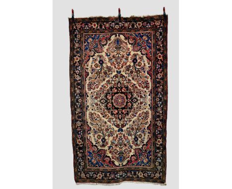 Hamadan rug, north west Persia, circa 1950s, 7ft. 11in. X 4ft. 8in. 2.13m. X 1.42m. Ivory cartouche shaped field with central