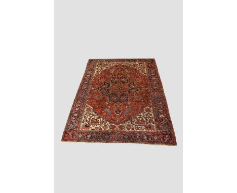 Good Heriz carpet, north west Persia, circa 1930s, 11ft. 11in. X 8ft. 6in. 3.63m. X 2.59m. Slight wear in places. Rust-red ca