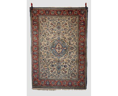 Attractive Qum rug, south central Persia, mid-20th century, 6ft. 10in. X 4ft. 10in. 2.08m. X 1.47m. Ivory field with pale blu