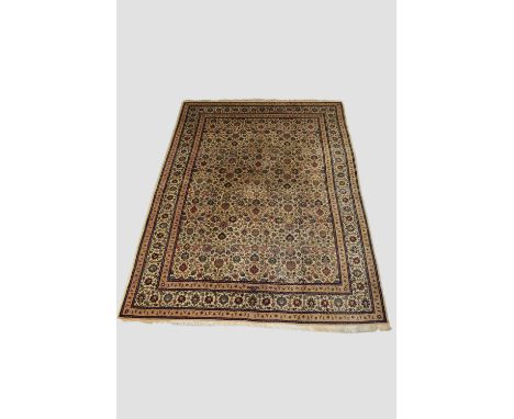 Tabriz carpet, signed, north west Persia, circa 1950s, 11ft. 9in. X 8ft. 9in. 3.58m. X 2.67m.   Ivory field closely filled wi