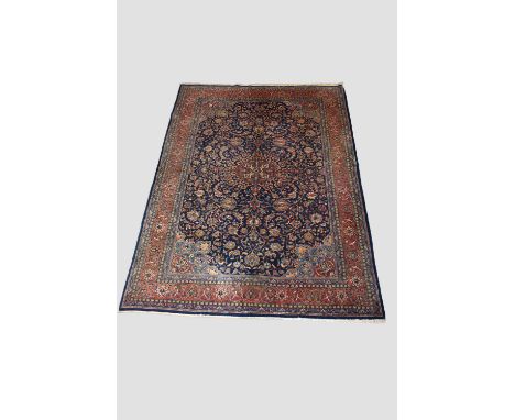 Attractive Kashan carpet, west Persia, circa 1940s-50s, 11ft. 4in. X 8ft. 3.45m. X 2.44m. Dark blue field; light terracotta c