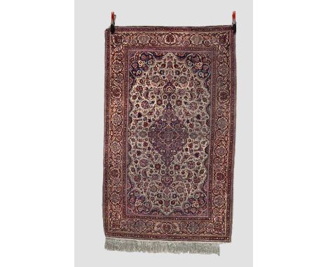 Fine silk Kashan rug, west Persia, early 20th century, 5ft. 11in. X 3ft. 7in. 1.80m. X 1.09m. Extensive wear; 'bite' to top l