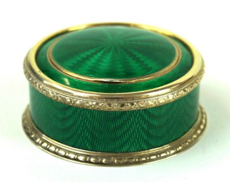 A Russian silver-gilt and guilloché enamel pill box
Of circular form, decorated with translucent green guilloche enamel throu