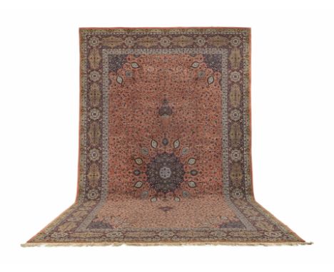 A large Tabriz carpet with Ardabil designNorth West Persia, woven in wools and silk, the rich madder field of flowering vines