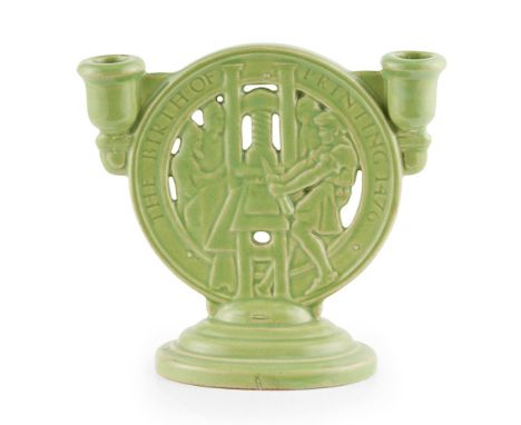 GILBERT BAYES (1872-1953) FOR ROYAL DOULTON  'THE BIRTH OF PRINTING' CANDELABRA, DATED 1935   covered in a green glaze and wi