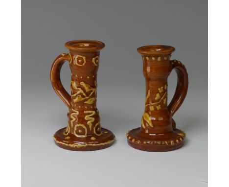 Edwin Beer Fishley (1832-1912) two Fremington Pottery Candlesticks, in Wrotham style with brown ground with thick applied sli