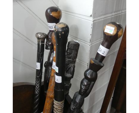 A carved Tribal walking Stick, H 84 cm, together with four other carved Tribal walking Sticks and a Chinese carved bamboo wal