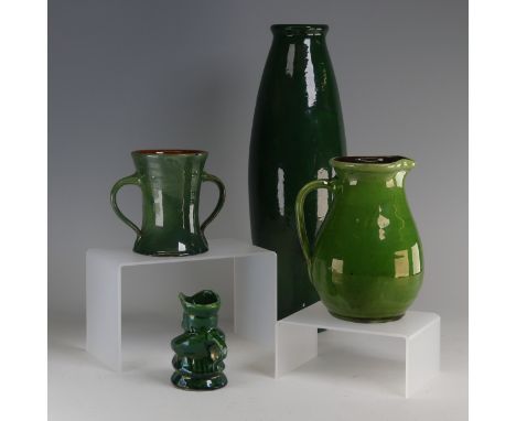 Edward Sadler; a Devonia Art Pottery Character&nbsp;Jug, in deep green glaze, incised signature to base, chip to foot and han