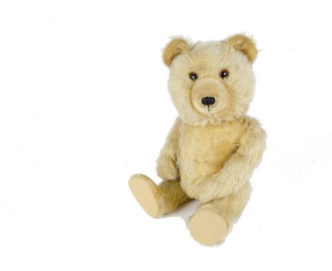 A Chiltern Ting - a - Ling Teddy Bear, 1950s, with golden mohair, orange and black glass eyes, inset short mohair muzzle, ear