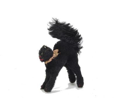A 1930s Steiff black mohair Tom Cat, with green and black glass eyes, red stitched nose, mouth and claws, whiskers, velvet ea
