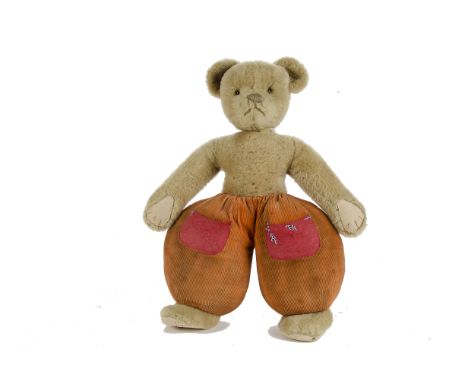 A Merrythought Dutch Teddy Bear, 1930s, with light brown wool plush, orange and black glass eyes, black stitched nose, mouth 