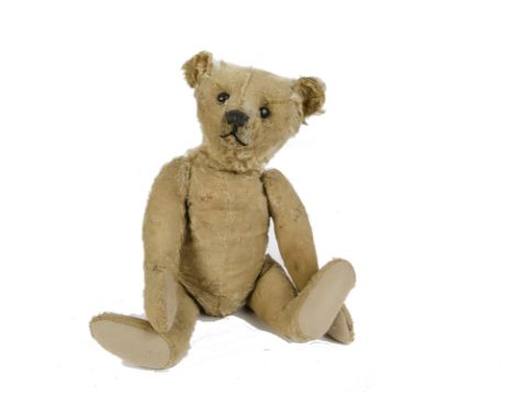 An early Steiff centre - seam Teddy Bear, circa 1910, with golden mohair, black boot button eyes, pronounced muzzle, black st